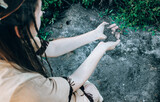 Young woman holding ashes near forest, ashes in hand close-up, tribal shaman near ashes. performing ancient ritual, wildfire concept, natural disaster concept