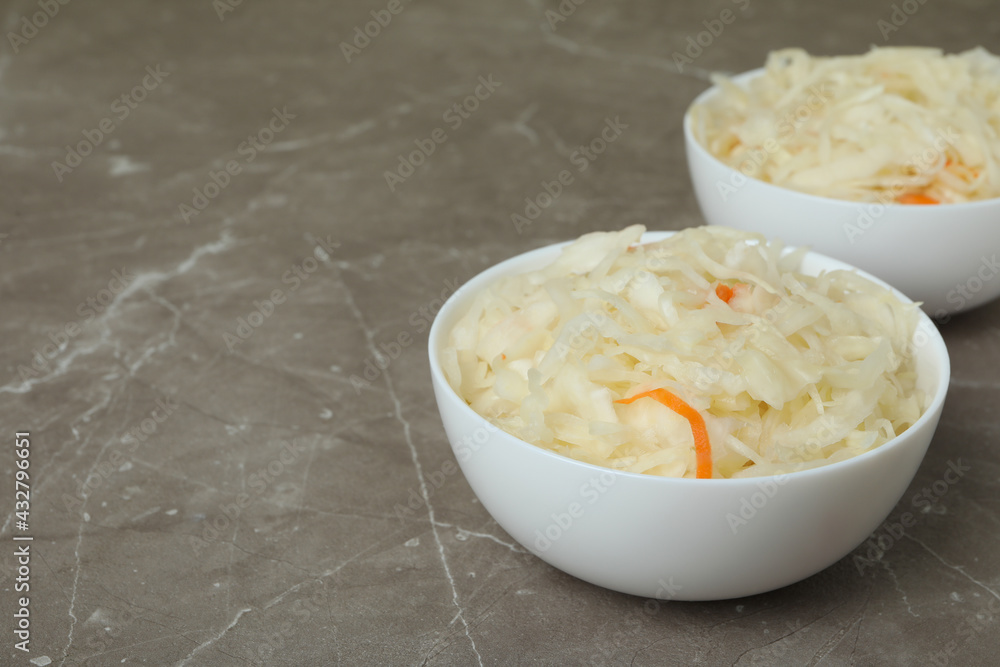Bowls of sauerkraut on gray textured background Bowls of sauerkraut on gray textured background