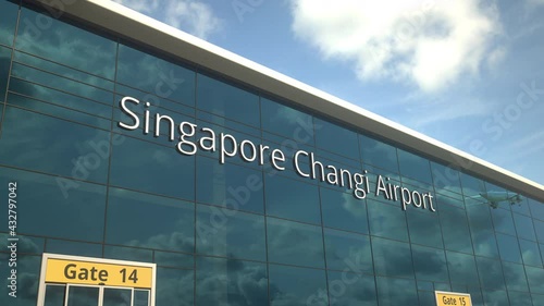 Commercial plane take off reflecting in the windows with Singapore Changi Airport text photo