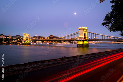 Illuminated Chain Bridge in Budapest with a purlpe sunset