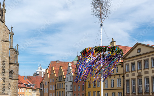 maypole in German town square with classic architecture and cathedral 
