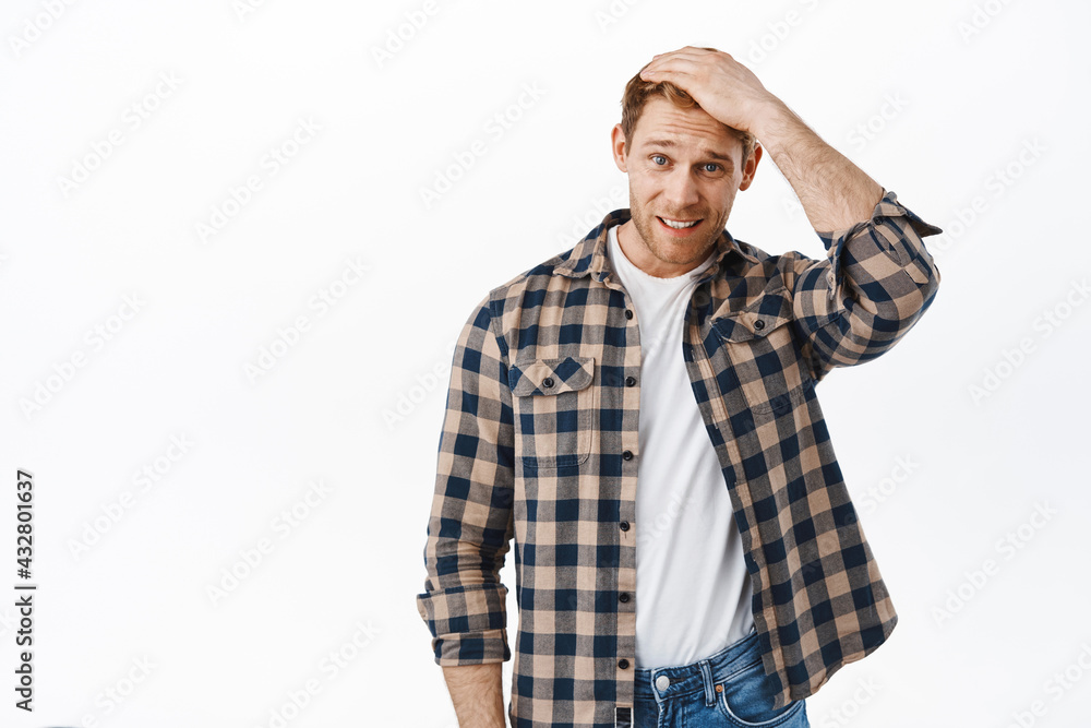 Awkward redhead man forgot remember, feeling uncomfortable apologizing, touching hair and looking guilty worried, say sorry, standing upset against white background Awkward redhead man forgot remember, feeling uncomfortable apologizing, touching hair and looking guilty worried, say sorry, standing upset against white background