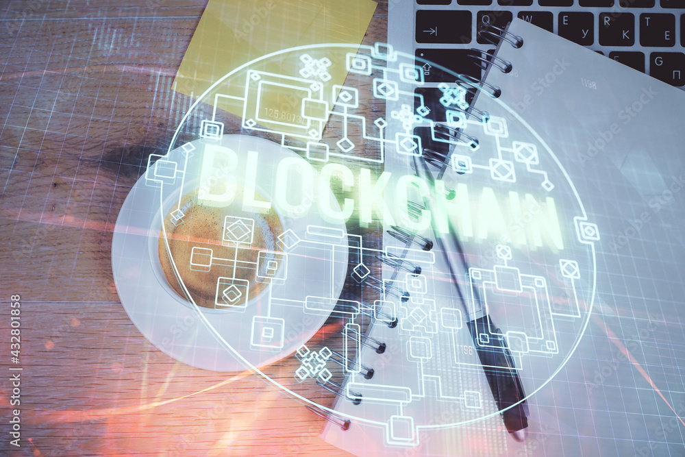 Blockchain theme hologram drawings over computer on the desktop ...