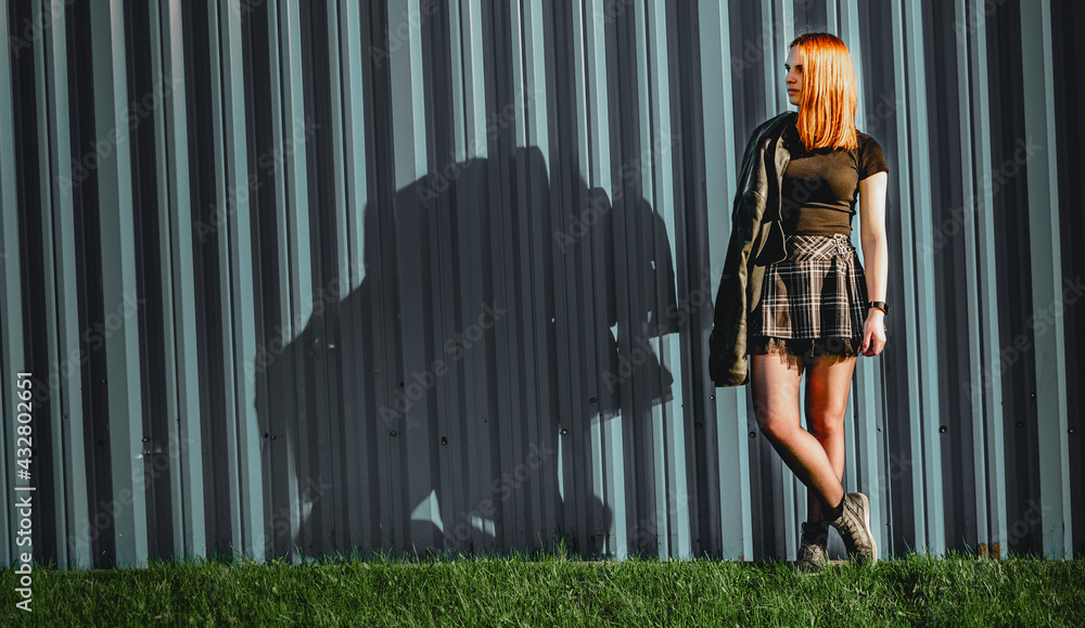 young woman or teenage girl standing outdoor on metal wall background young woman or teenage girl standing outdoor on metal wall background