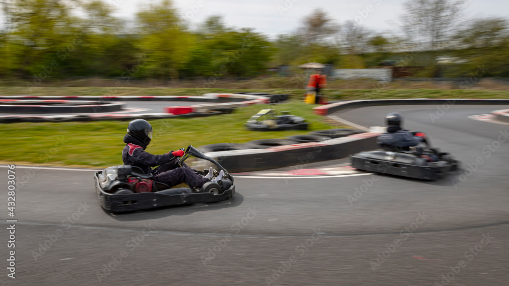 Fototapeta premium A panning shot of a racing kart as it circuits a track.