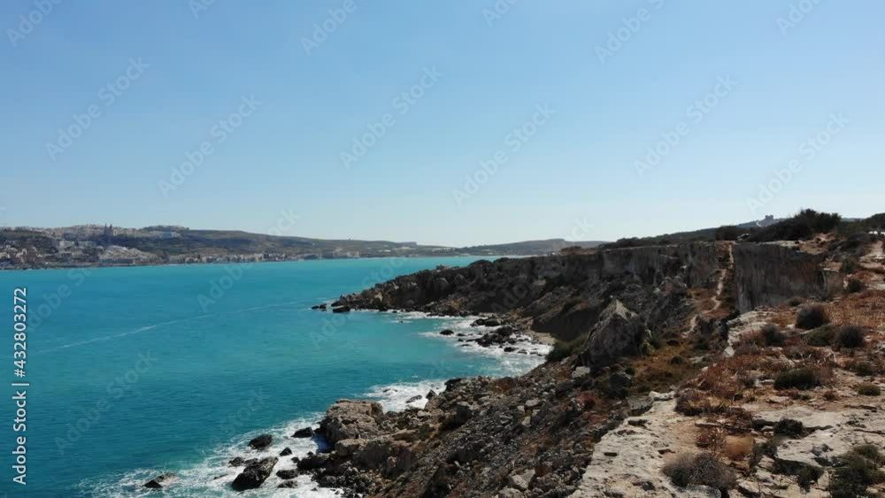 Aerial forward horizon view of rocky cliffs, coast with calm blue sea in Mellieha bay, Malta Aerial forward horizon view of rocky cliffs, coast with calm blue sea in Mellieha bay, Malta