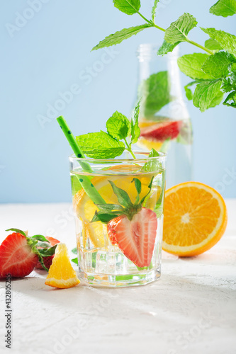 Summer detox beverage concept. Citrus fruit drinks with ice. Healthy diet cocktail with fresh berries and mint