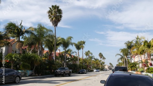 California typical suburban street, tropical Oceanside USA. Different colorful houses row. Generic american homes, buildings facade, townhouse exterior architecture. Residential district real estate.