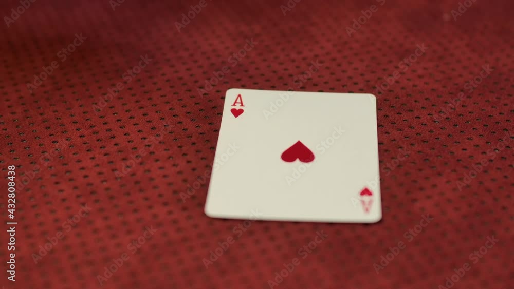 Slow motion closeup of a card dealer revealing an Ace of hearts on the game table. Slow motion closeup of a card dealer revealing an Ace of hearts on the game table.