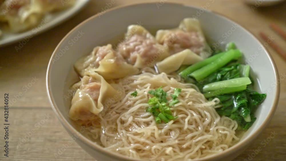 egg noodles with pork wonton soup or pork dumplings soup and vegetable - Asian food style egg noodles with pork wonton soup or pork dumplings soup and vegetable - Asian food style