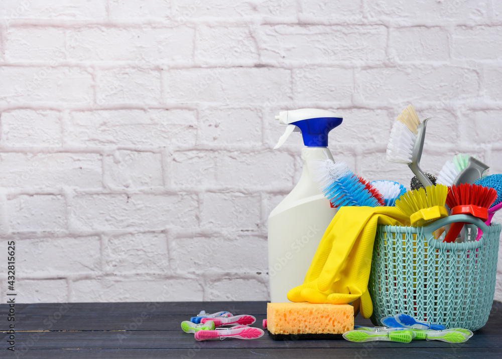 blue plastic basket with brushes, sponges and rubber gloves for cleaning blue plastic basket with brushes, sponges and rubber gloves for cleaning