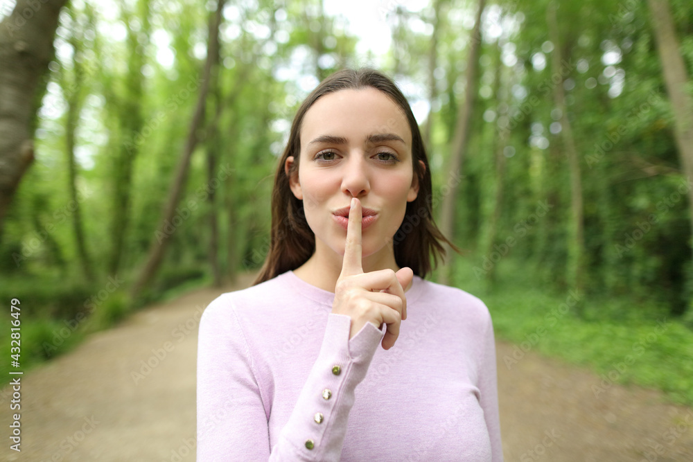 Beautiful woman asking for silence in a forest Beautiful woman asking for silence in a forest