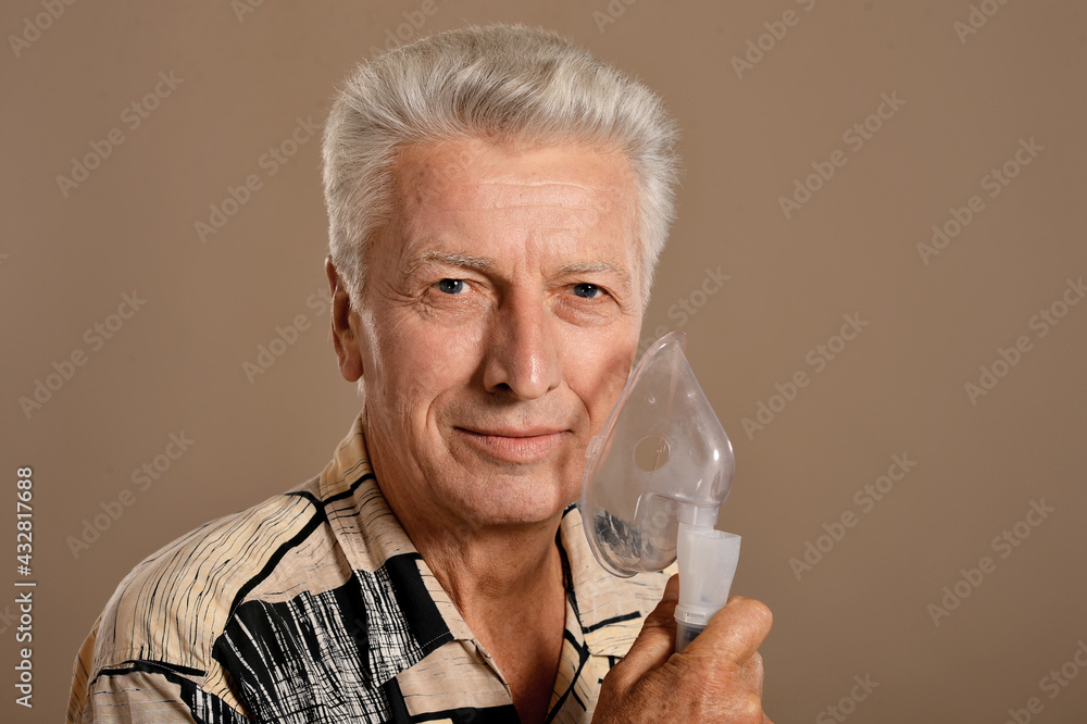 Portrait of sick senior man with inhaler Portrait of sick senior man with inhaler