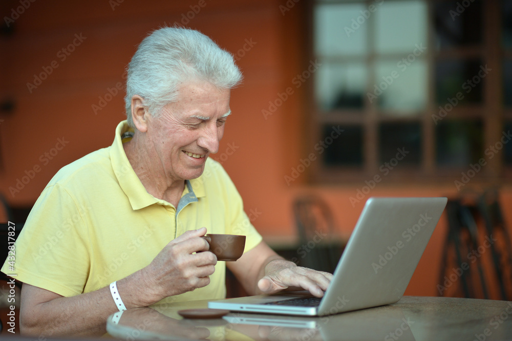 senior man using laptop senior man using laptop