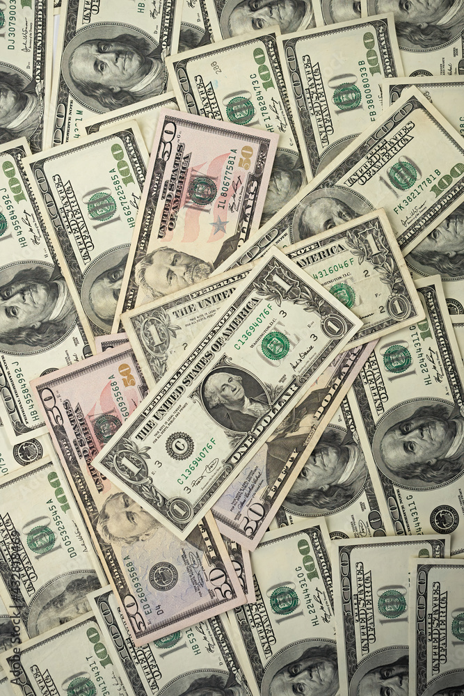A money pile of various US banknotes with president Washington portrait on top. Cash of dollar bills, paper currency background. A money pile of various US banknotes with president Washington portrait on top. Cash of dollar bills, paper currency background.