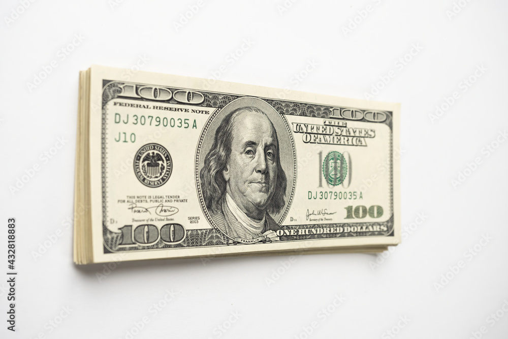 A money pile of stacked one hundred US banknotes with president Franklin portrait on white background. Cash of hundred dollar bills, paper money currency. A money pile of stacked one hundred US banknotes with president Franklin portrait on white background. Cash of hundred dollar bills, paper money currency.