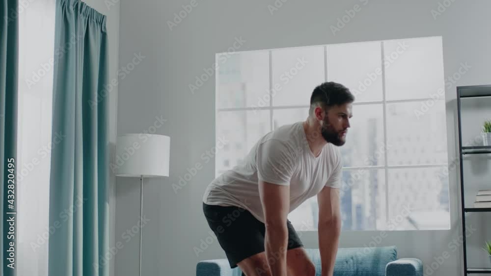 Bearded muscular sportsman prepares for competitions at home Bearded muscular sportsman prepares for competitions at home