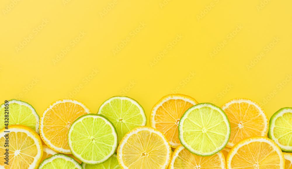sliced lime and lemon on yellow background sliced lime and lemon on yellow background