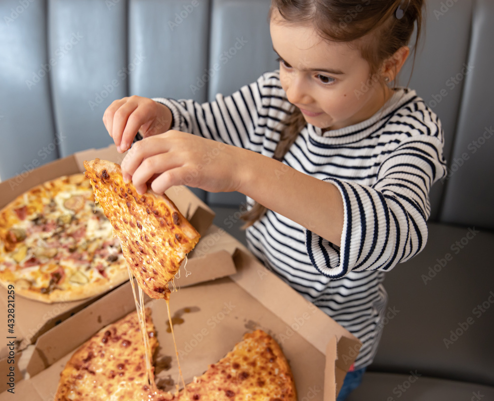 Little girl with a piece of cheese pizza in her hands.
