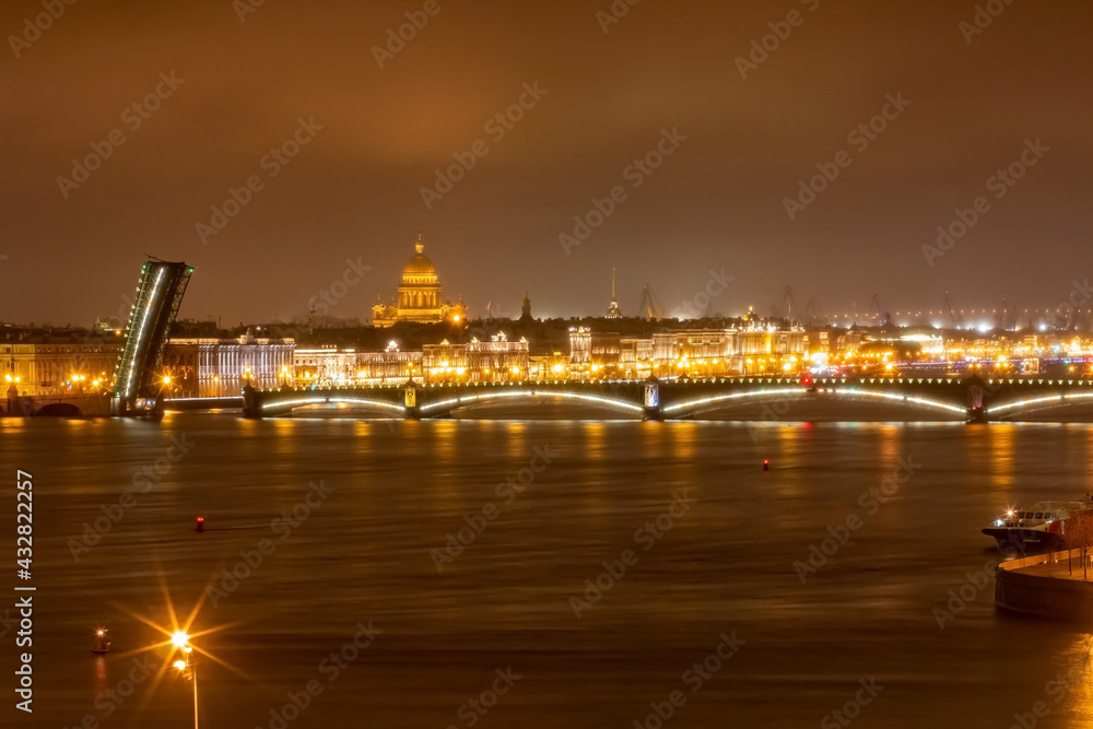 View of the embankment of the city of St. Petersburg at night with drawbridges