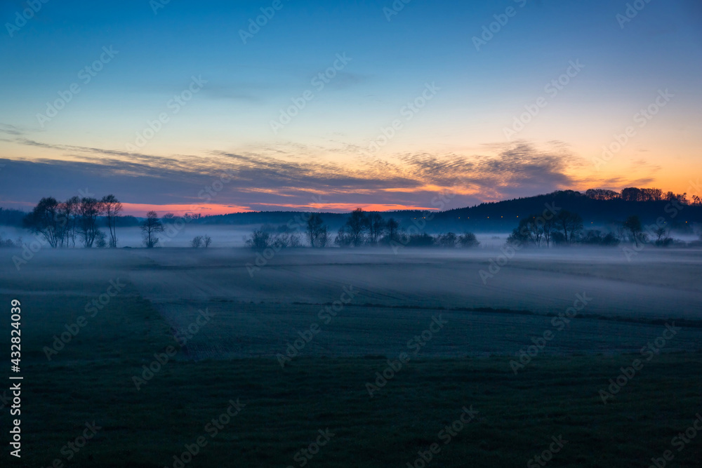 Misty meadow at sunset in Poland