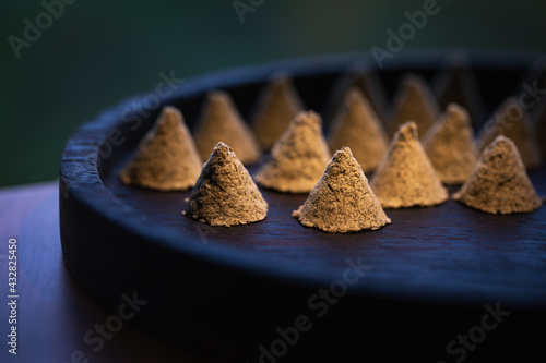 Photos The conical moxa used for treatment is placed in a wooden dish