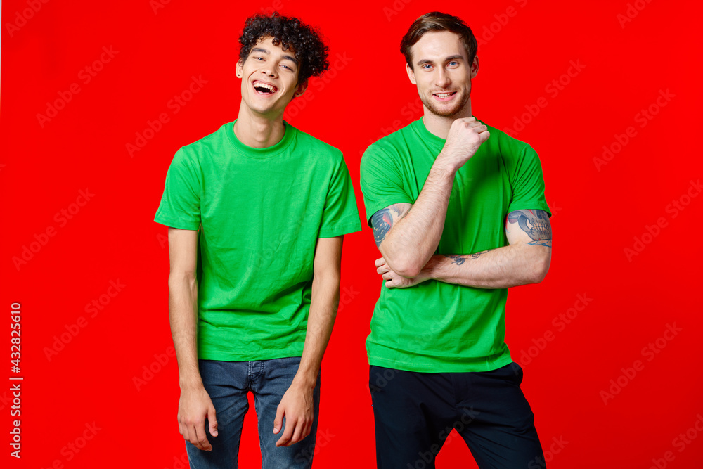 two men in green t-shirts are standing next to friendship two men in green t-shirts are standing next to friendship