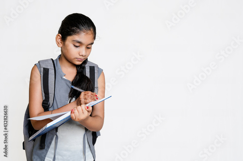 indian girl writing on notebook