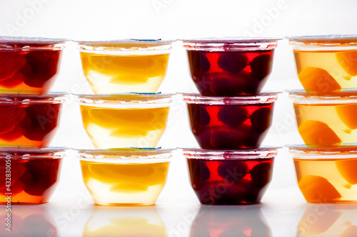 Bowls of colorful jelly, with pieces of fruits. Side view. The concept of healthy desserts and home preservation