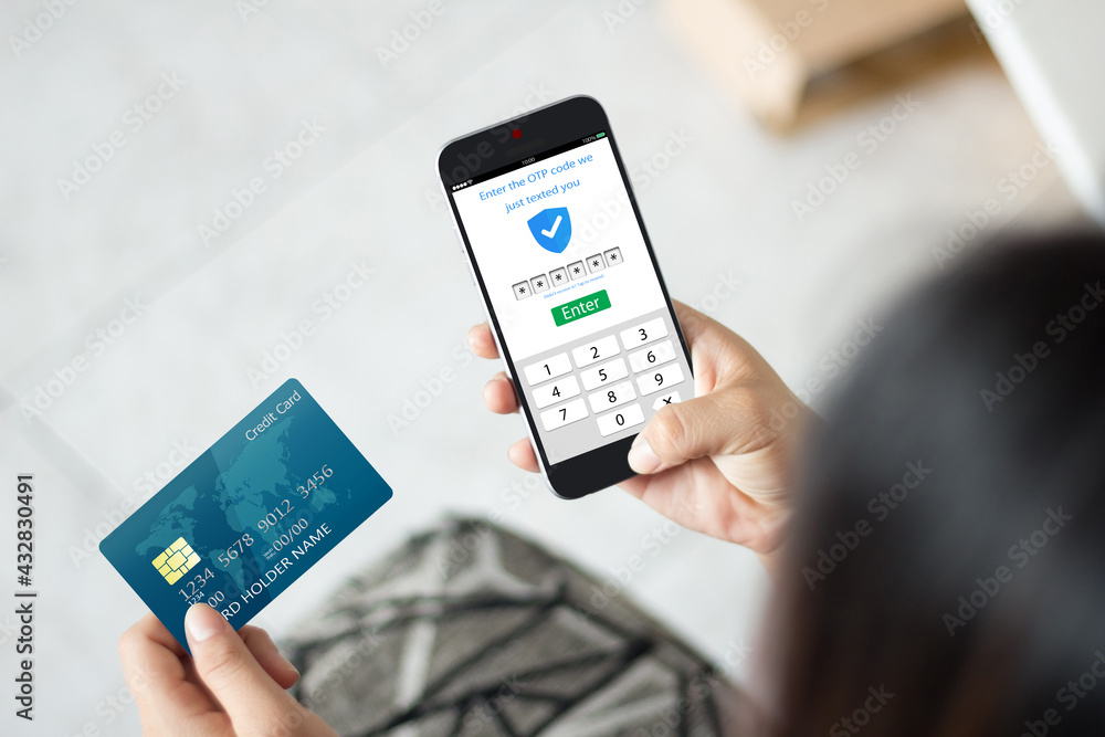 Secure payment OTP PASSWORD CONCEPT.female hands using mobile phone and holding credit card Secure payment OTP PASSWORD CONCEPT.female hands using mobile phone and holding credit card