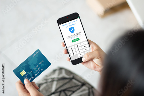 Secure payment OTP PASSWORD CONCEPT.female hands using mobile phone and holding credit card