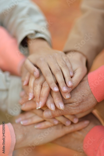 cropped image, family putting  hands together © aletia2011