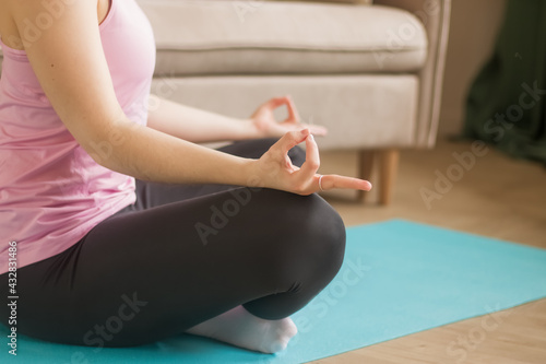 Fototapeta Naklejka Na Ścianę i Meble -  Yoga class. A woman meditates at home.