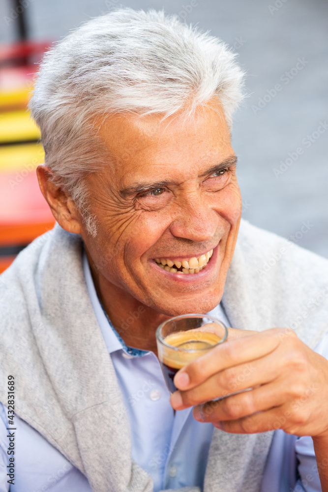 Close up smiling handsome man holding cup of coffee Close up smiling handsome man holding cup of coffee