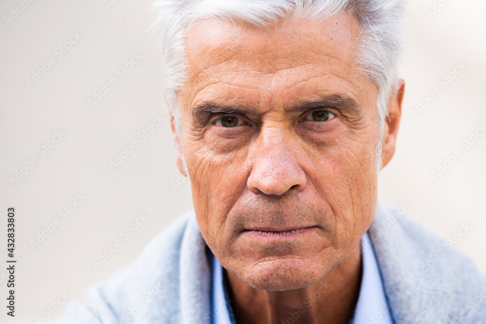 Close up serious older man eyes looking Close up serious older man eyes looking
