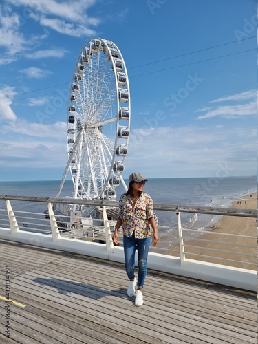  The Ferris Wheel The Pier at Scheveningen, The Hague, The Netherlands on a Spring day, young woman on the beach