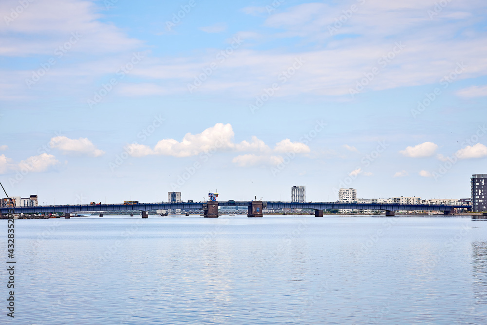 a large blue bridge in denmark on a sunny day