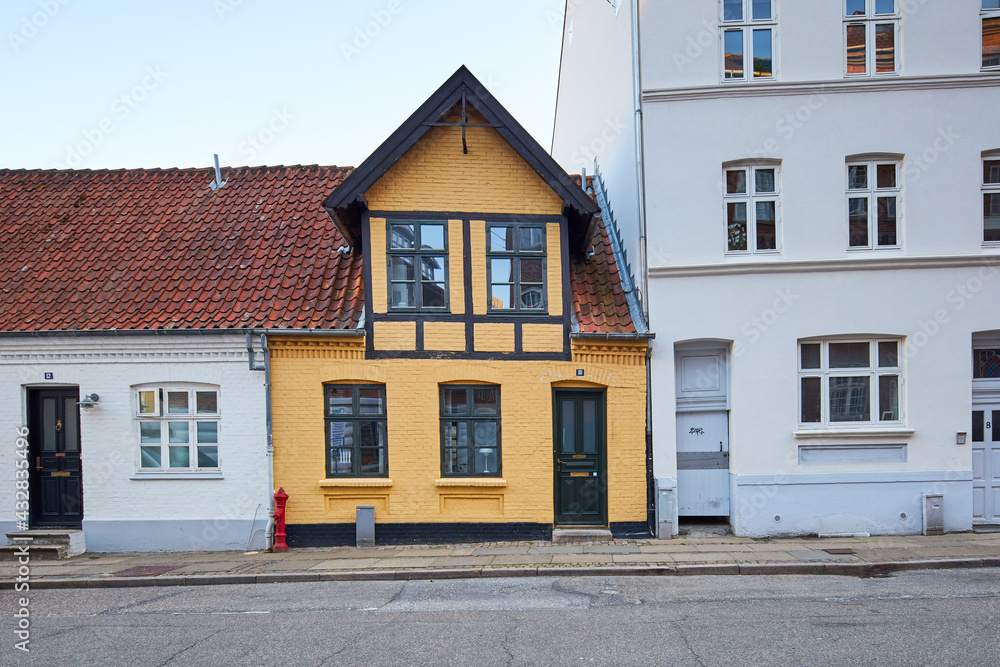a yellow and black strip tiny house