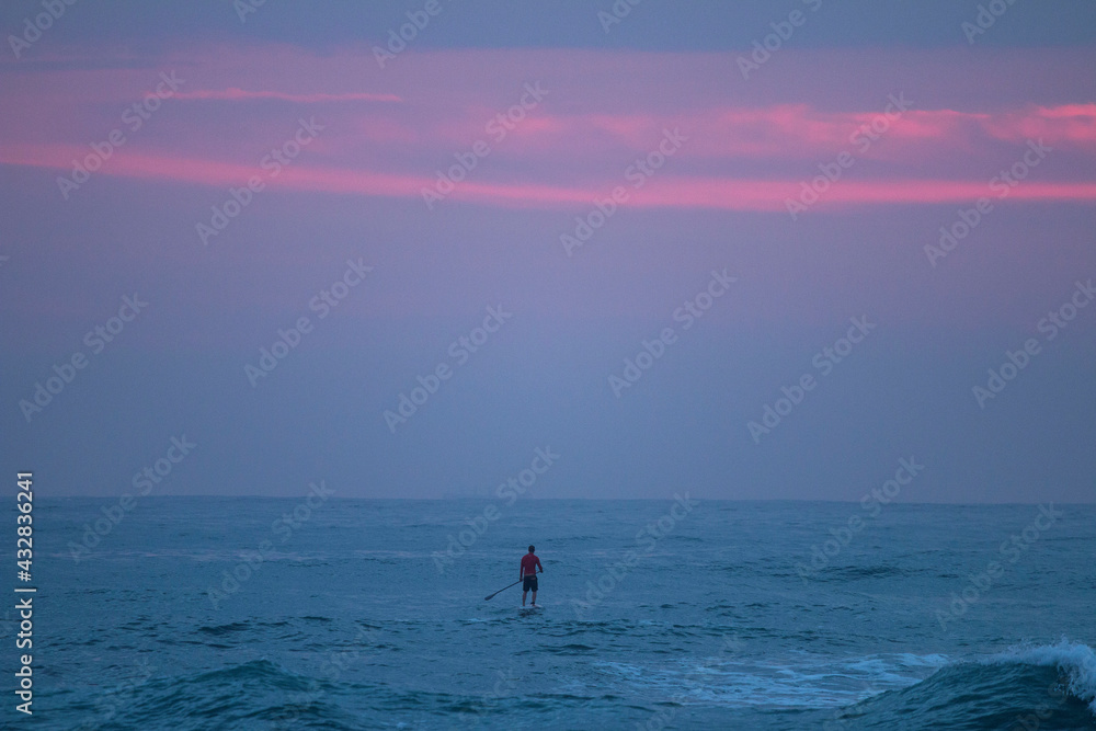 Lone paddler on the open sea