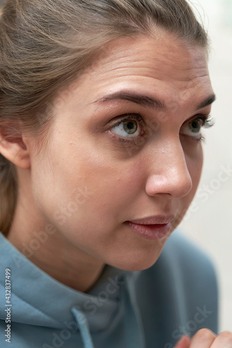 Facial portrait of cute brunette with hair pulled back