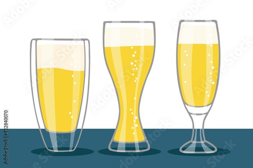 Set of Beer glasses isolated on table. Three different forms glasses of beer with foam and bubbles. Oktoberfest background Concept for pub, bar, restaurant menu, party decor, beverage drinks template
