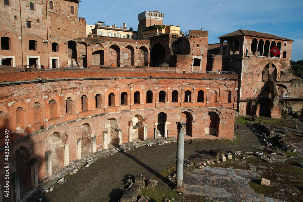 View on the Trajan Markets, archaeological remains, columns and ruins, blue sky.