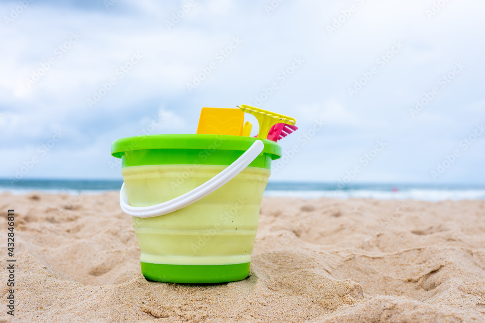 Beach toys on the sand with towel Beach toys on the sand with towel