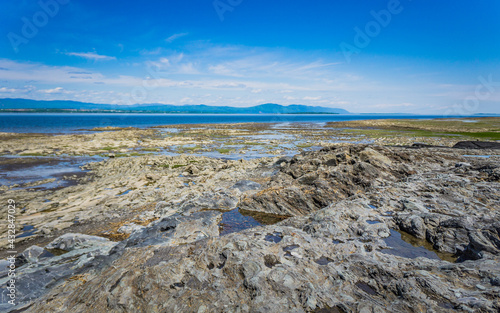 Sunny day on the rocky beach of Saint Vallier, on the St Lawrence River in the province of Quebec in Canada