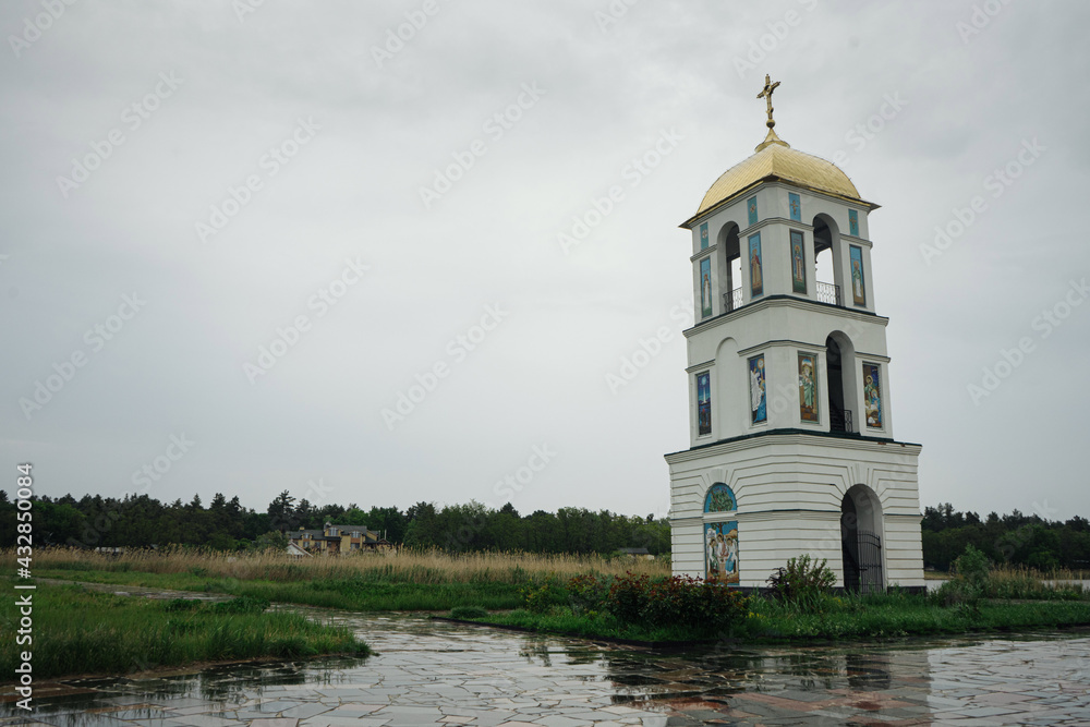 Classic orthodox village church with natural rainy background Classic orthodox village church with natural rainy background