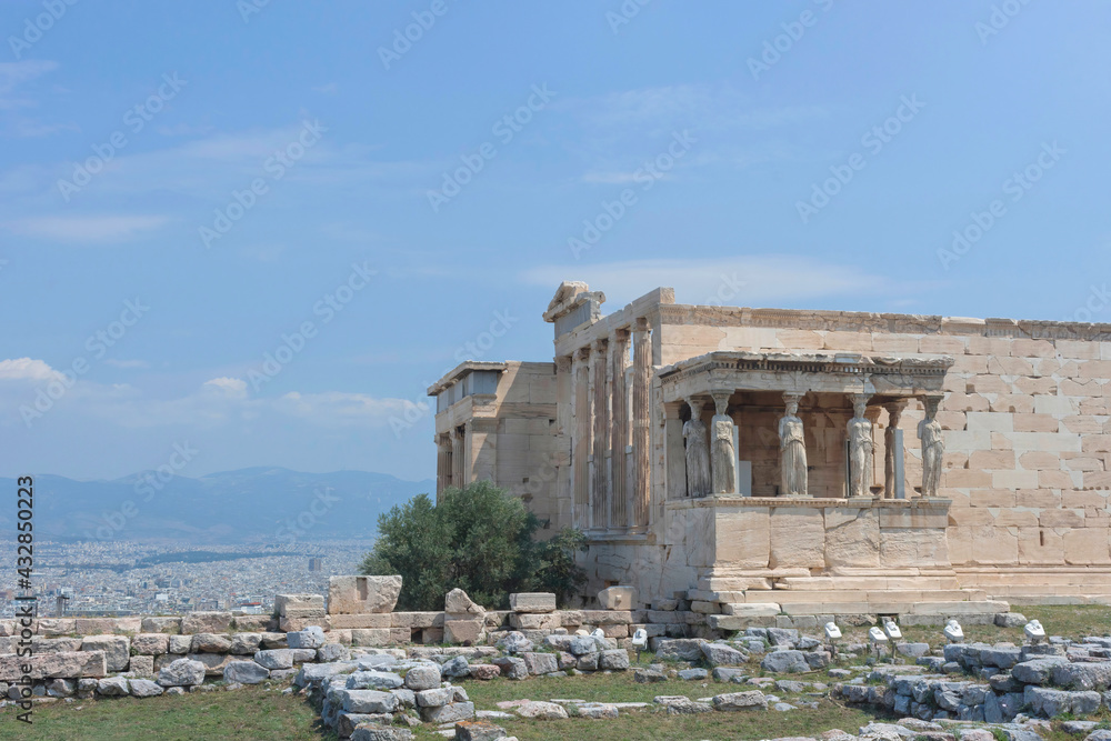 Ancient temple with beautiful Caryatids on Acropolis hill, famous tourist attraction in Athens, Greece, in sunny summer day