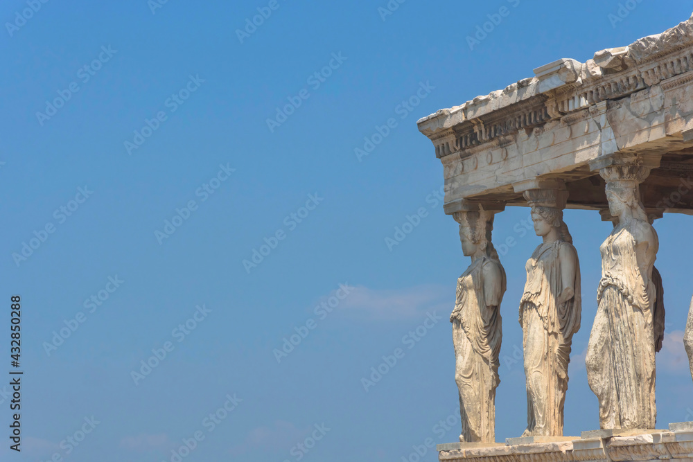 Fototapeta premium Architecture detail of the Caryatids of a ancient temple on Acropolis hill, famous tourist attraction in Athens, Greece, in sunny summer day