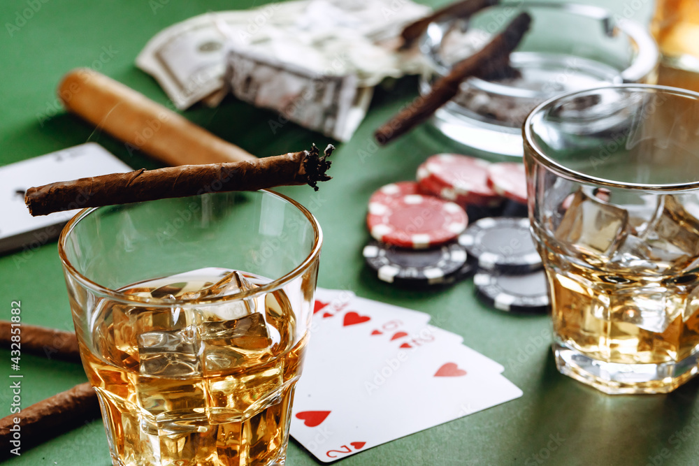 Glass of whiskey, cigar, playing cards and chips on green background - obrazy, fototapety, plakaty 