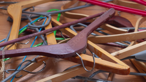 A pile of clothes hangers in a mess before cleaning the wardrobe