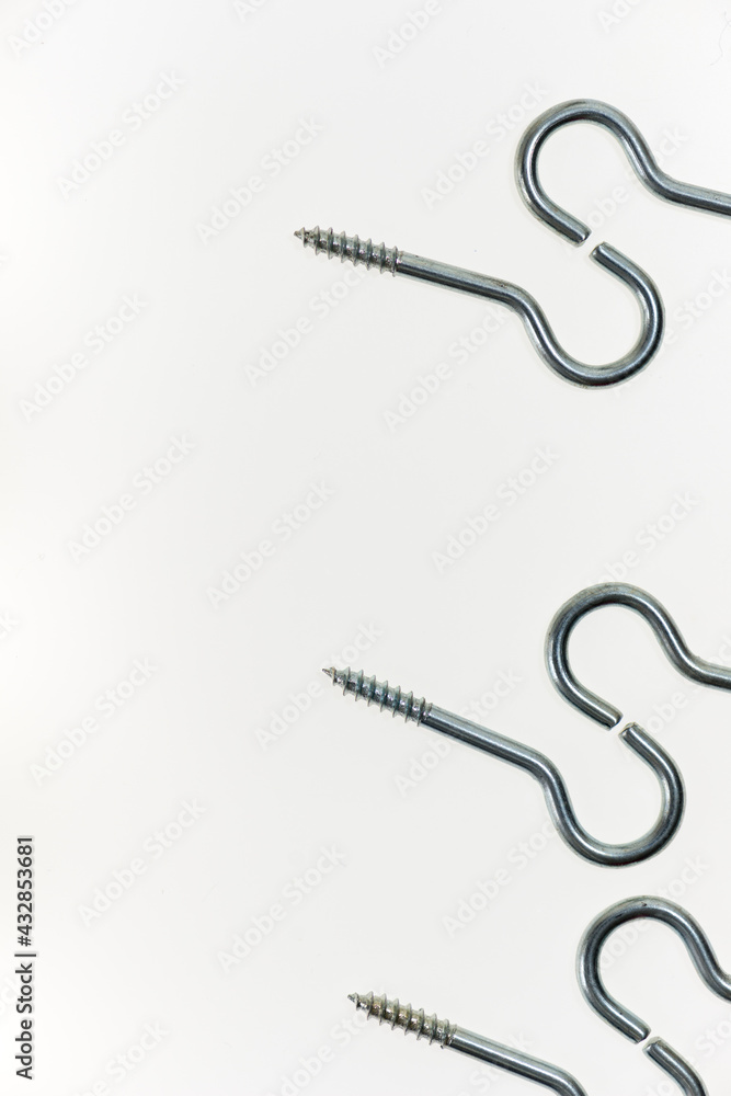 medium sized metal screw hooks on white, photographed with a macro lens, shallow depth of field medium sized metal screw hooks on white, photographed with a macro lens, shallow depth of field